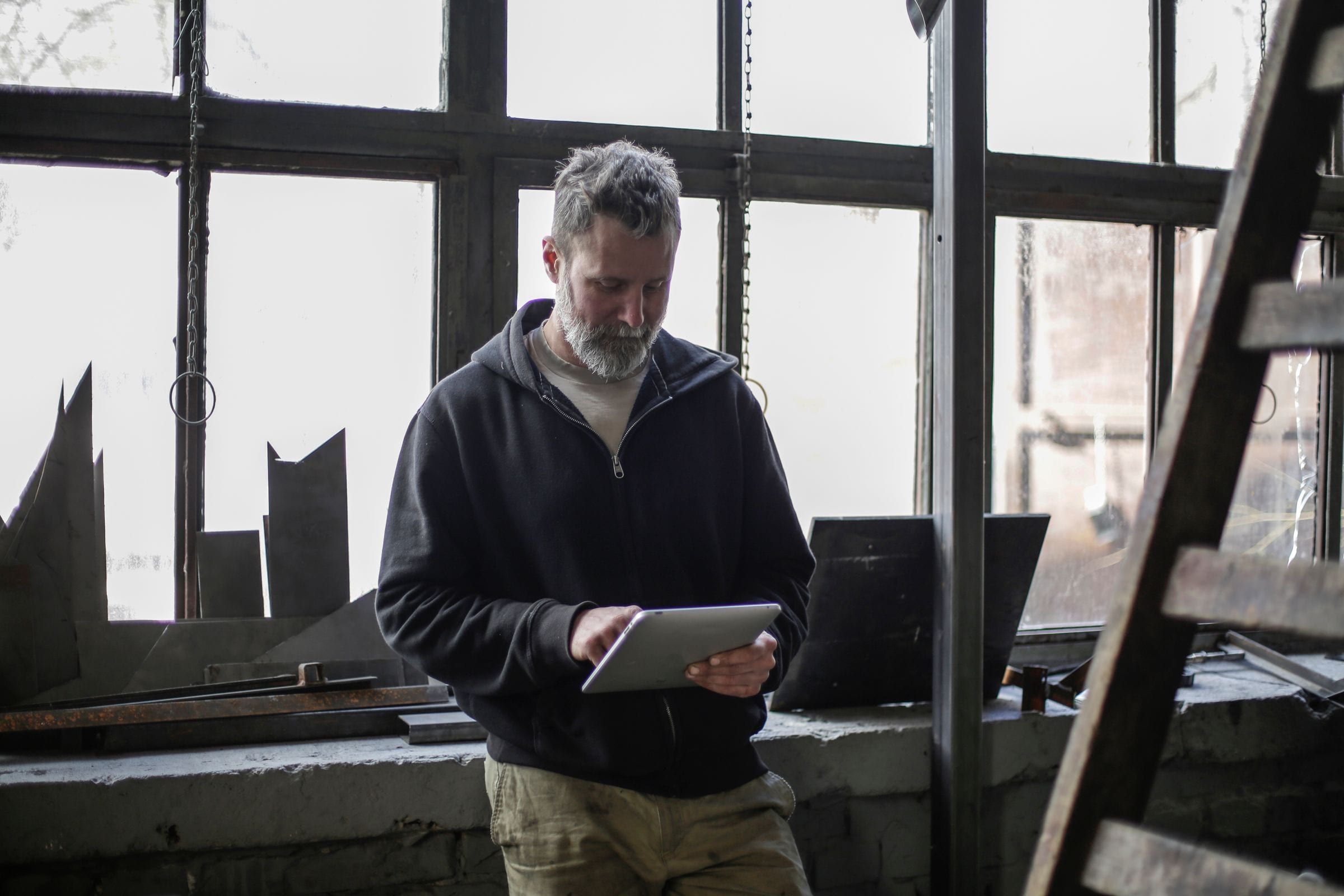 Vakman gebruikt een tablet in de werkplaats